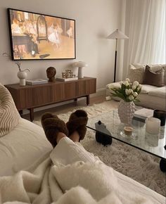 a living room filled with furniture and a flat screen tv mounted to the side of a wall