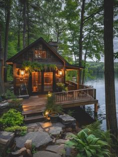 a small cabin in the woods with lights on and steps leading up to it's deck