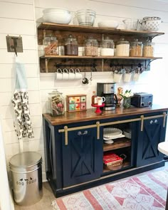 the inside of a kitchen with shelves, cabinets and other items on display in it