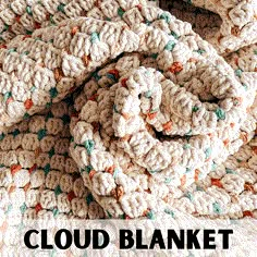 a crocheted blanket laying on top of a bed