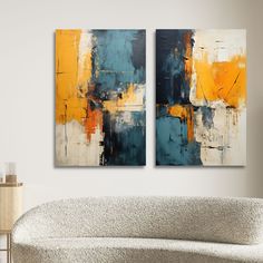 two paintings are hanging on the wall above a couch