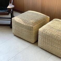 two wicker stools sitting next to each other