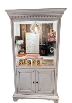 an old white china cabinet with drawers