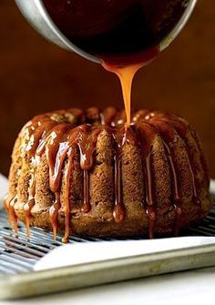 someone pouring caramel sauce onto a bundt cake