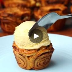 a cupcake on a plate with a knife sticking out of it