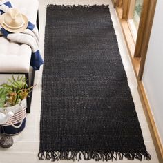 a living room with a black rug on the floor