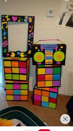 there are two boxes made to look like an old school disco dance machine and one is colorful