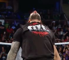 a man standing on top of a wrestling ring