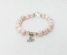 Stunning pink marbled glass beads accented with crystals and silver hope charm. Size of the bracelet is 7.5 inches with high quality stretchable cord! Pink Heart-shaped Stretch Bracelet As Gift, Pink Adjustable Stretch Bracelet, Fun Style, Handmade Pink Heart-shaped Stretch Bracelet, Adjustable Hand-strung Pink Crystal Bracelet, Adjustable Heart-shaped Pink Crystal Bracelet, Motivational Bracelets, Hope Bracelet, Awareness Bracelet, Rose Bracelet