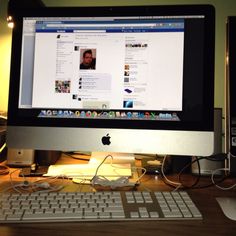 an apple desktop computer sitting on top of a wooden desk