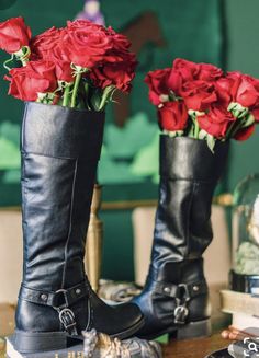 two boots with roses in them sitting on a table