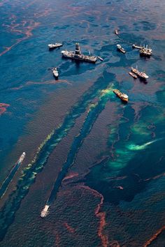 an aerial view of several ships in the water with algae growing on it's sides