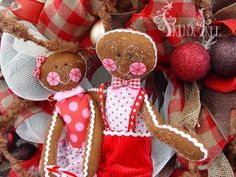 two teddy bears are standing next to each other on the front door decorated for christmas