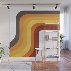 an orange and yellow wall mural in a living room with wooden flooring, white walls and