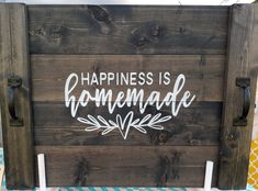 a wooden sign that says happiness is homemade