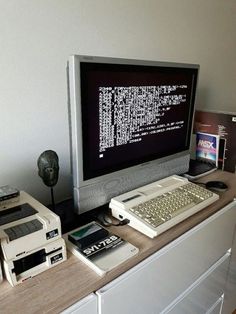 a computer monitor sitting on top of a desk next to an old fashioned keyboard and mouse