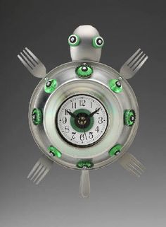 a clock with green eyes and forks around it