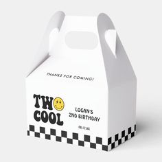 a white carton with a smiley face on the front and black checkered sides