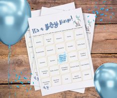 a baby shower game with balloons and blue confetti on the table next to it