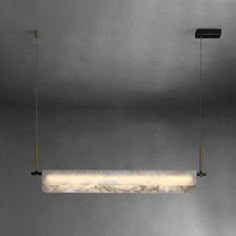 the suspended light fixture is made out of marble