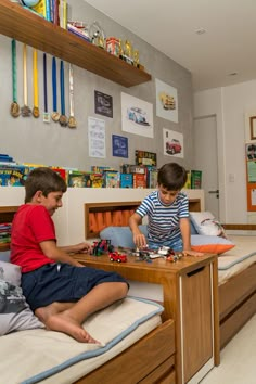 two young boys playing with toys in their bedroom