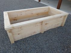 a wooden bench sitting on top of gravel