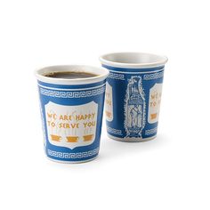 two cups with coffee in them sitting next to each other