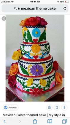 a multi - tiered cake with colorful flowers on it's sides is displayed