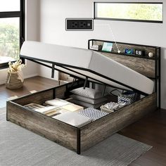 a bed that is sitting in the middle of a room with drawers on each side