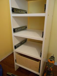 an empty shelf in the corner of a room with some tools on top of it