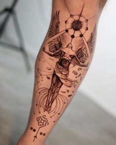 a man's leg with a tattoo on it and an image of a bird