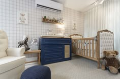 a baby's room with a crib, rocking chair and teddy bear