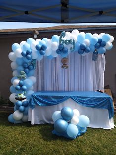 a blue and white party setup with balloons