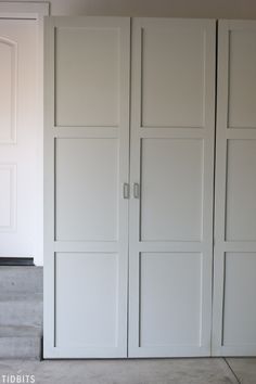 an empty room with white closets and doors