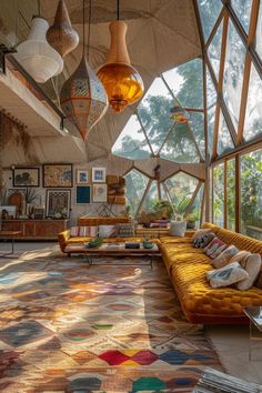 a living room filled with lots of furniture and large windows covered in light colored fabric