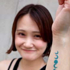 a woman with a small tattoo on her arm