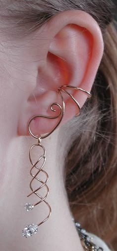 This is our amazing Ear Saver Ear Cuff with a beautiful spiral dangling with Marque Stone from the cuff. This cuff is non pierced and hugs the side of your ear comfortably and securely. The Ear Saver is versatile, you can remove this dangle and add any light weight earring part to hang off of the Ear Saver. If you desire only the Ear Saver Ear Cuff, it is available in a separate listing. This piece will arrive in a Gift Box and include simple fitting instructions. Perfect for gift giving Yellow Gold Wedding Rings, Ear Cuff Diy, Wire Ear Cuffs, Ear Wraps, Minimalist Ear Cuff, Wedding Rings Diamond, Ear Cuff Jewelry, Wire Jewelry Designs, Wrap Earrings