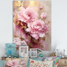 a bed with pink flowers on it next to a white dresser and wall mounted painting