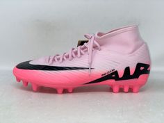 a pair of pink and black soccer cleats