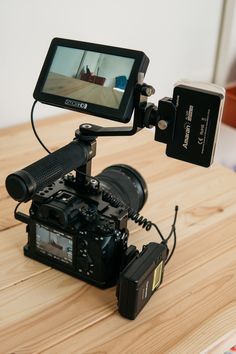 a video camera sitting on top of a wooden table