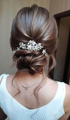 a woman wearing a hair comb with flowers on it