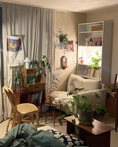 a living room filled with furniture and plants