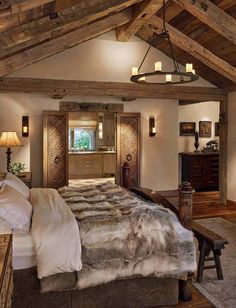 a large bed sitting under a wooden beam in a bedroom