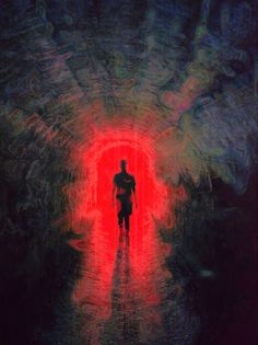 a man walking through a tunnel with red light