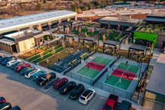 an aerial view of a tennis court and parking lot