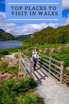 a woman walking across a wooden bridge with the words top places to visit in wales