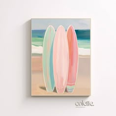 three surfboards are standing on the beach