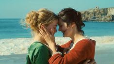 two women hugging each other on the beach