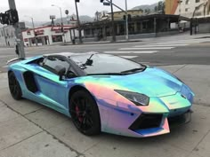 a blue and pink car is parked on the street