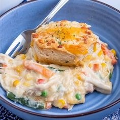 a blue plate topped with food and a fork